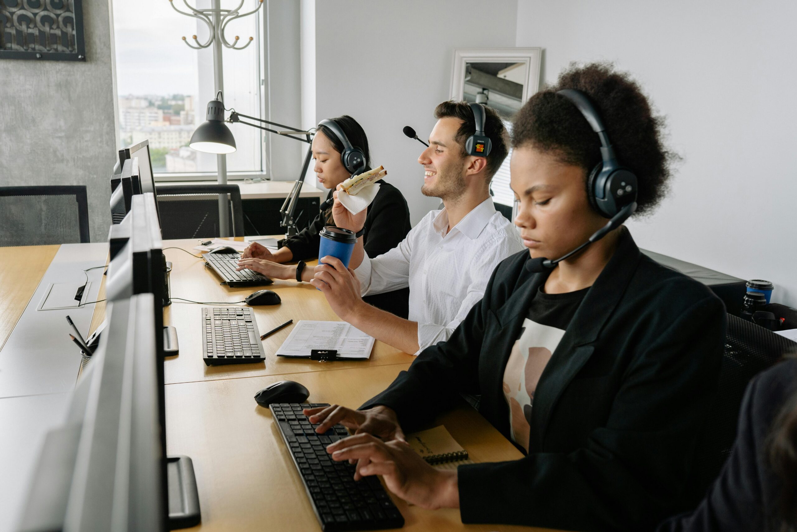 A diverse group of call center agents working together in a modern office setting.